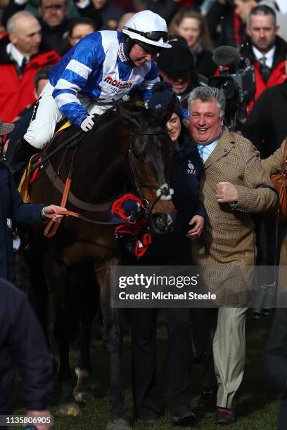 Jockey Bryony Frost on Frodon celebrates with trainer Paul Nicholls after victory in the Ryanair Chase race during St Patrick's Thursday at...