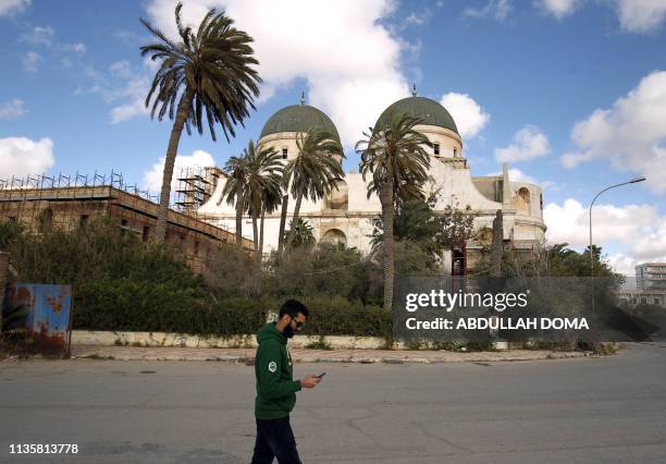 Man walks past Benghazi Cathedral, designed by Italian architects Guido Ottavo and Cabiati Ferrazza and built between 1929 and 1939, in Libya's...