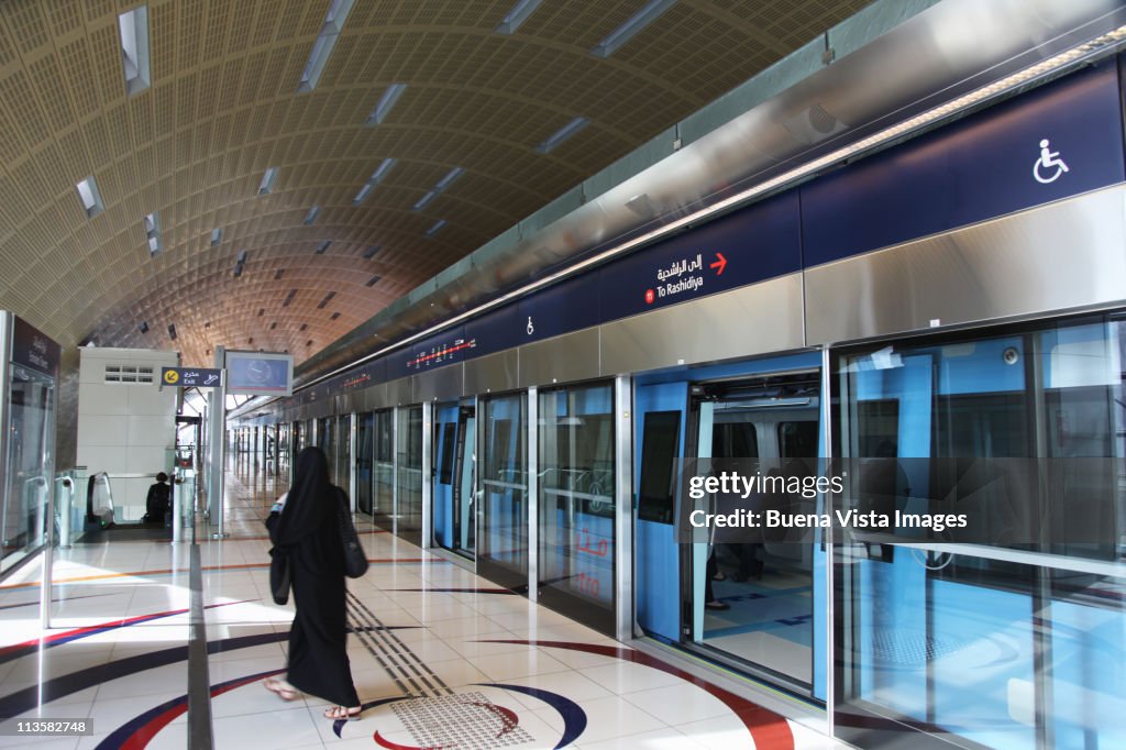 Dubai, arab woman in a metro station.