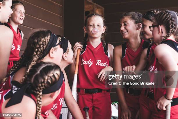 girl blowing bubble gum in dugout during softball game - comic strip bildbanksfoton och bilder