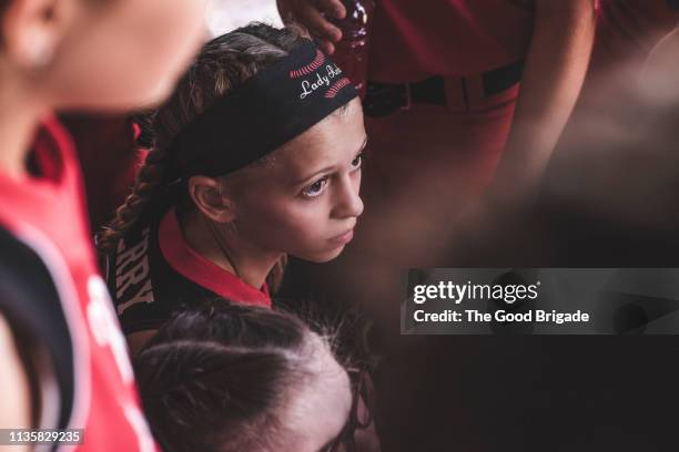 softball players talking in dugout - softball sport stock pictures, royalty-free photos & images