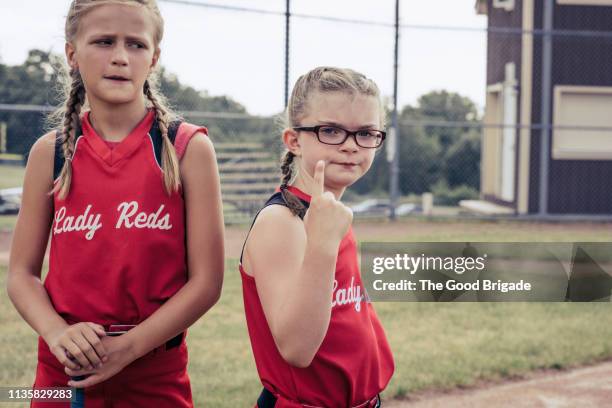 serious softball players standing on field - toughness stock pictures, royalty-free photos & images