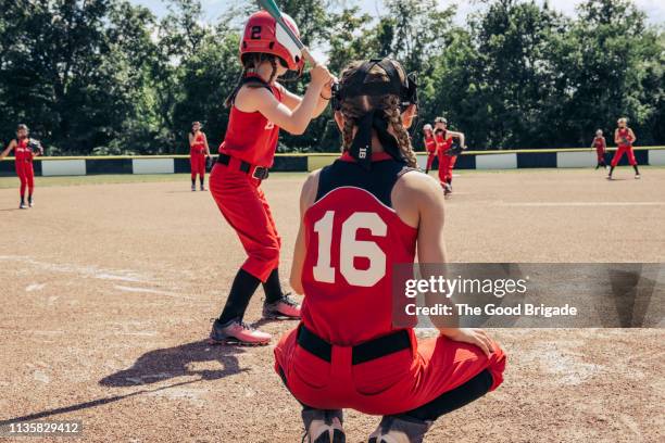 girls softball team practicing on field - girls softball stock pictures, royalty-free photos & images