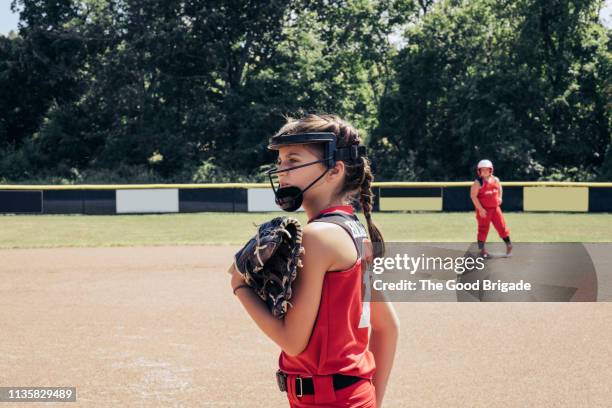 softball player standing on pitcher's mound - softball glove stock pictures, royalty-free photos & images