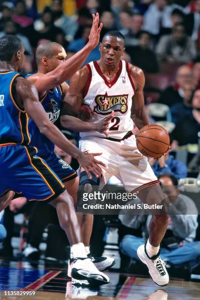 Theo Ratliff of the Philadelphia 76ers handles the ball against the Detroit Pistons on February 9, 1999 at the First Union Center in Philadelphia,...