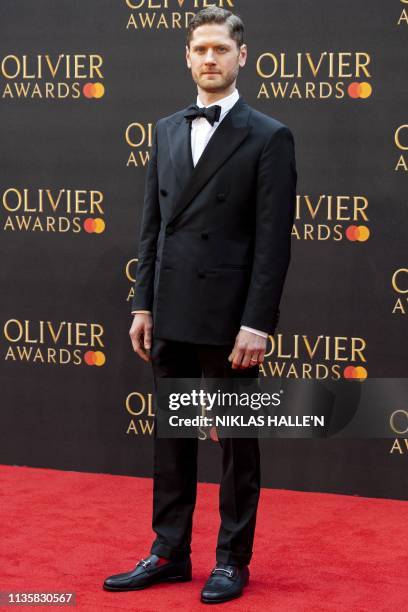 Actor Kyle Soller, winner of the best actor award for his part in the play "The Inheritance", poses on the red carpet upon arrival to attend The...