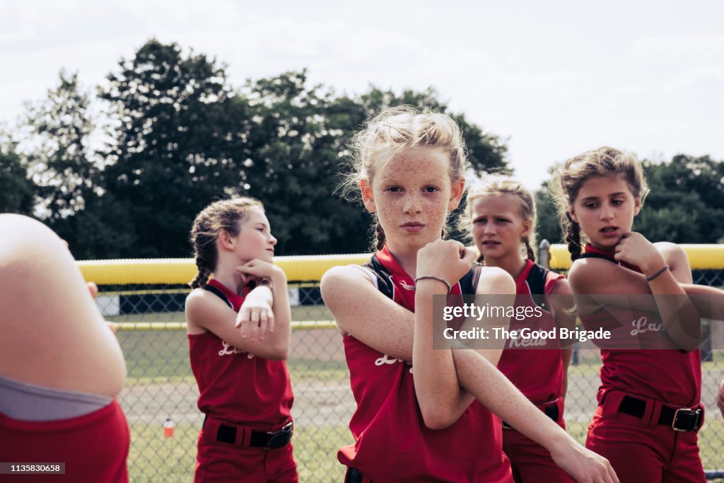 Portrait of confident softball player stretching