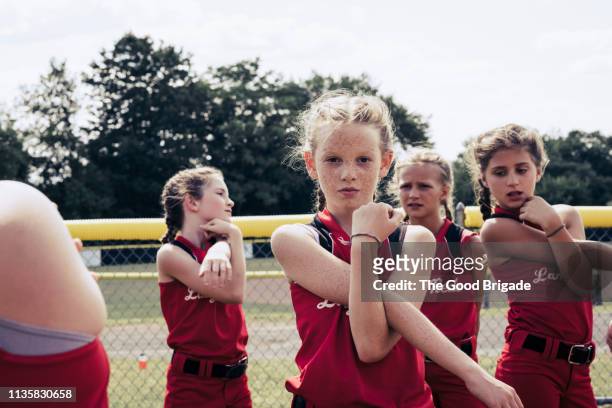 Portrait of confident softball player stretching