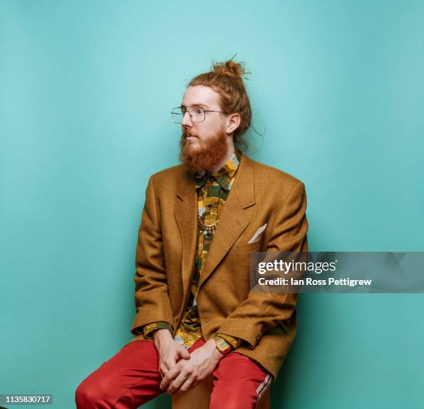 bearded hipster man wearing jacket on blue background - hipster beard plain background stock-fotos und bilder