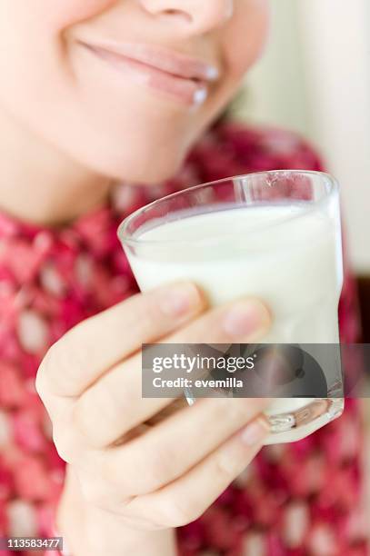 young woman drinking milk - vitamin a stock pictures, royalty-free photos & images