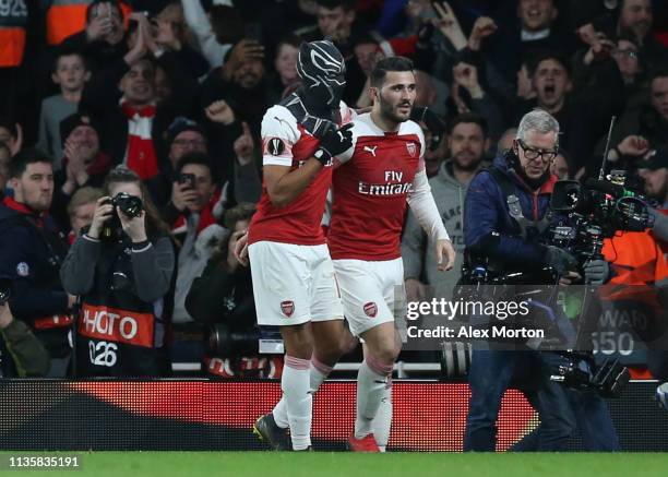 Pierre-Emerick Aubameyang of Arsenal dons a Black Panther mask as he celebrates after scoring his team's third goal with Sead Kolasinac of Arsenal...