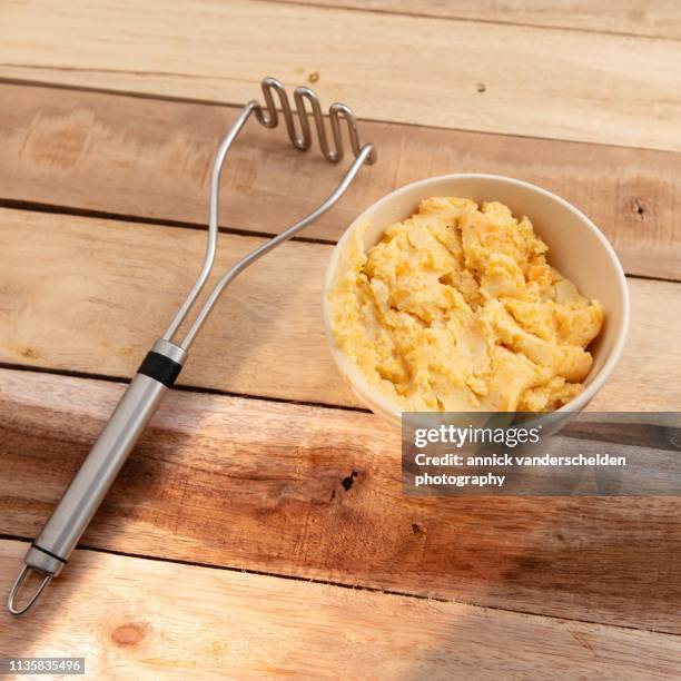 potato and carrot mash - potato masher stock pictures, royalty-free photos & images