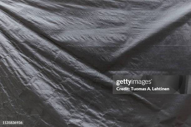full frame background of a wrinkled gray tarp texture - tarpaulin stock-fotos und bilder