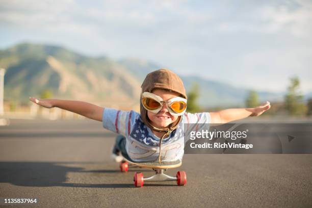 young boy flying auf skateboard - boy flying stock-fotos und bilder