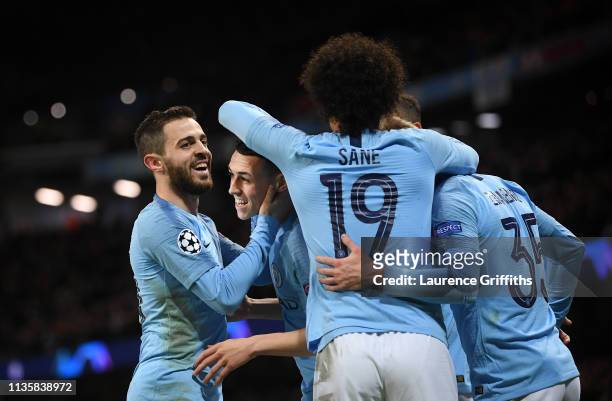 Phil Foden of Manchester City is congratulated by Bernardo Silva and Leroy Sane after scoring the sixth goal during the UEFA Champions League Round...