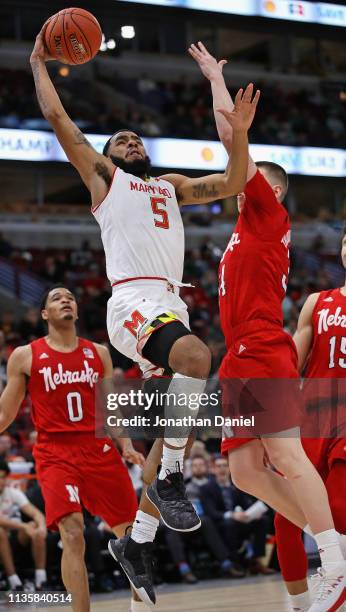 Eric Ayala of the Maryland Terrapins drives to the basket past Thorir Thorbjarnarson of the Nebraska Cornhuskers at the United Center on March 14,...