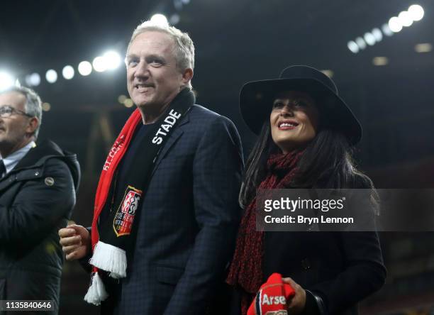 Stade Rennais owner François-Henri Pinault and wife Salma Hayek walk on the pitch the UEFA Europa League Round of 16 Second Leg match between Arsenal...
