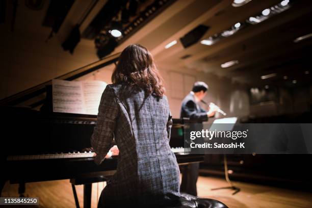 playing piano and flute at classical music concert - classical musician stock pictures, royalty-free photos & images