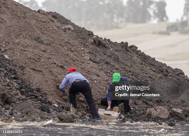 Ethiopian Airlines officials collect soil from the crash site to give to Family members visiting the crash site of Ethiopian Airlines Flight ET302 on...