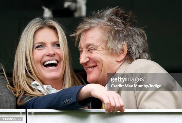Penny Lancaster and Sir Rod Stewart watch the racing as they attend day 3 'St Patrick's Thursday' of the Cheltenham Festival at Cheltenham Racecourse...