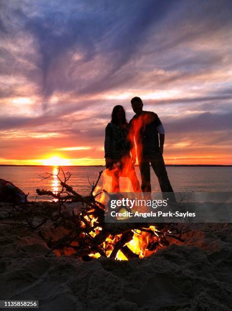 beach bonfire at sunset - bonfire beach stock pictures, royalty-free photos & images