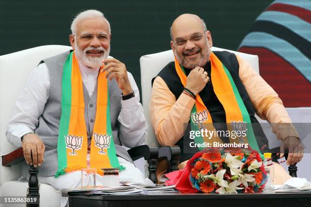 Narendra Modi, India's prime minister, left, and Amit Shah, president of the Bharatiya Janata Party, attend an event marking the release of the...
