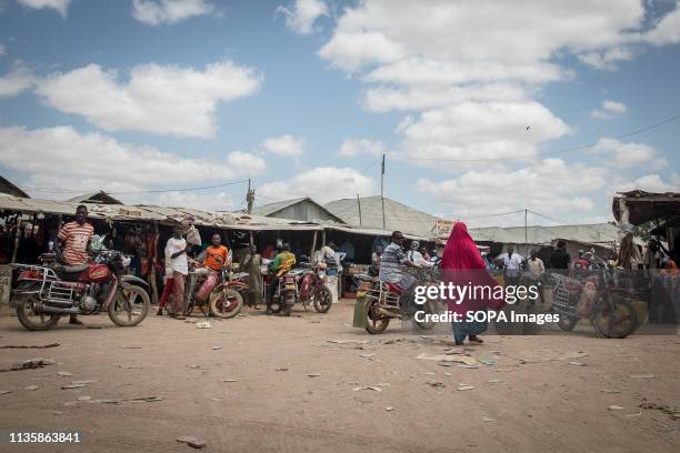 Woman seen walking through a busy street in the refugee camp. Dadaab is one of the largest refugee camps in the world. More than 200,000 refugees...