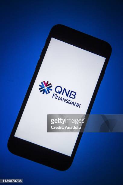 Finansbank logo is seen on a smartphone, in Ankara, Turkey on April 5, 2019.