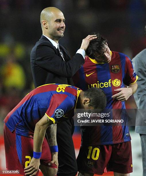 Barcelona's coach Josep Guardiola celebrates with Barcelona's Argentinian forward Lionel Messi and Barcelona's Brazilian defender Dani Alves after...