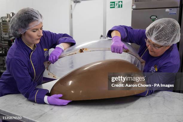 Chocolatiers cast half a giant chocolate egg at Cadbury World in Birmingham that they are making to celebrate Easter.