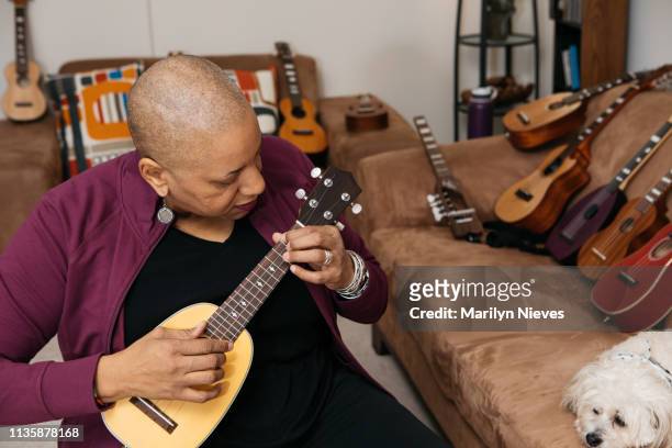 playing the ukelele - disability collection stock pictures, royalty-free photos & images