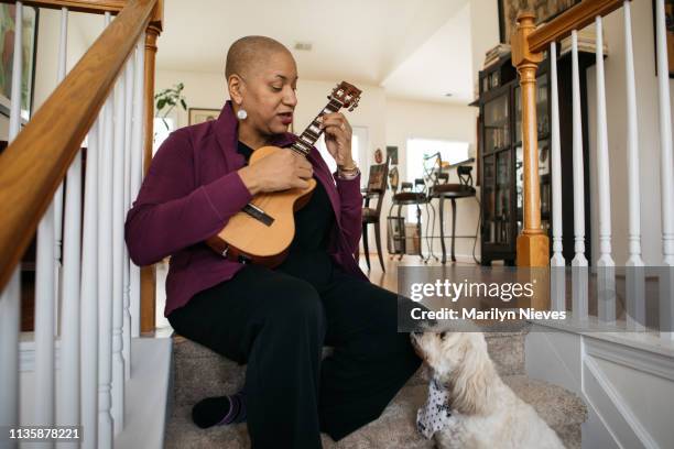 playing the ukelele - best song stock pictures, royalty-free photos & images