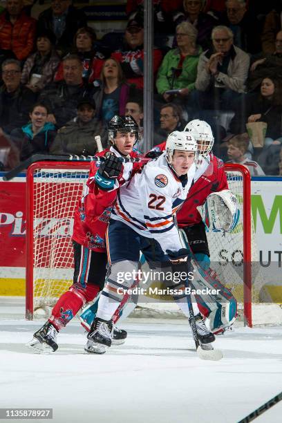 Roman Basran defends the net as Kyle Crosbie of the Kelowna Rockets back checks Martin Lang of the Kamloops Blazers at Prospera Place on March 9,...