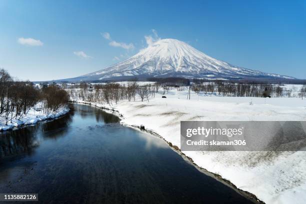 beautiful landscape view of little fuji mountain yotei and village near niseko hokkaido japan - vulkan yotei stock-fotos und bilder