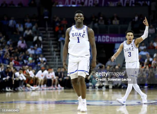 Teammates Zion Williamson and Tre Jones of the Duke Blue Devils react after defeating the Syracuse Orange 84-72 during their game in the quarterfinal...