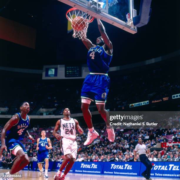 Michael Finley of the Dallas Mavericks dunks the ball against the New Jersey Nets on March 17, 1999 at the Continental Airlines Arena in East...