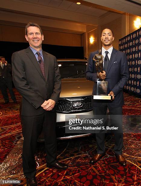 Derrick Rose of the Chicago Bulls receives the 2010-11 Kia NBA Most Valuable Player Award from Kia's Tim Chaney on May 3, 2011 in Lincolnshire,...