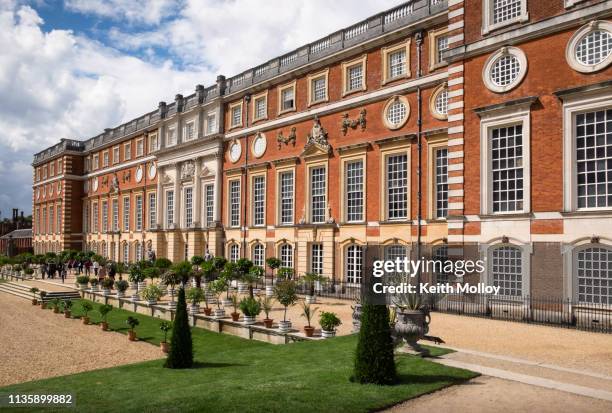 facade and gardens at hampton court palace. - hampton court palace stock pictures, royalty-free photos & images