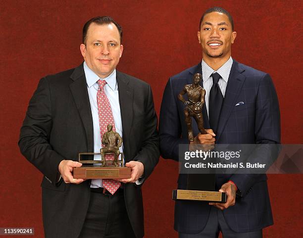 Coach Tom Thibodeau of the Chicago Bulls poses with the 2010-11 Kia NBA Coach of the Year Award alongside Derrick Rose with the Kia NBA Most Valuable...