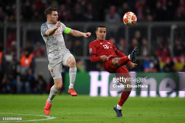 Thiago Alcantara of Bayern Muenchen and James Milner of Liverpool compete for the ball during the UEFA Champions League Round of 16 Second Leg match...
