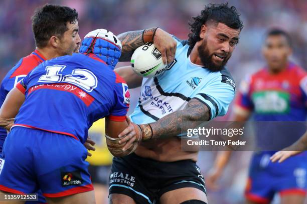 Andrew Fifita of the Cronulla Sharks is tackled during round one NRL match between the Newcastle Knights and the Cronulla-Sutherland Sharks at...