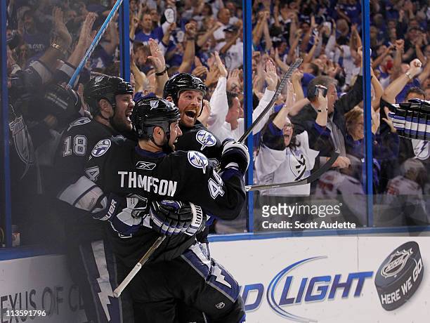 Ryan Malone of the Tampa Bay Lightning celebrates his goal with teammates Adam Hall and Nate Thompson during the third period against the Washington...