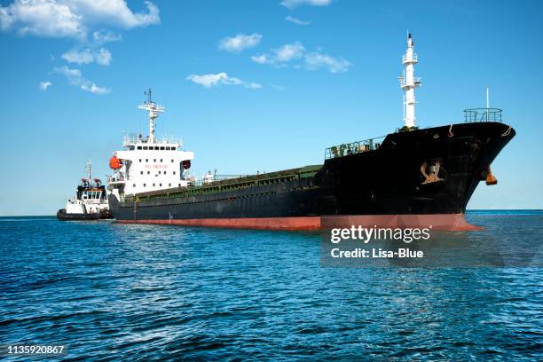 ship and tugboat in the harbor - oil tanker stock pictures, royalty-free photos & images