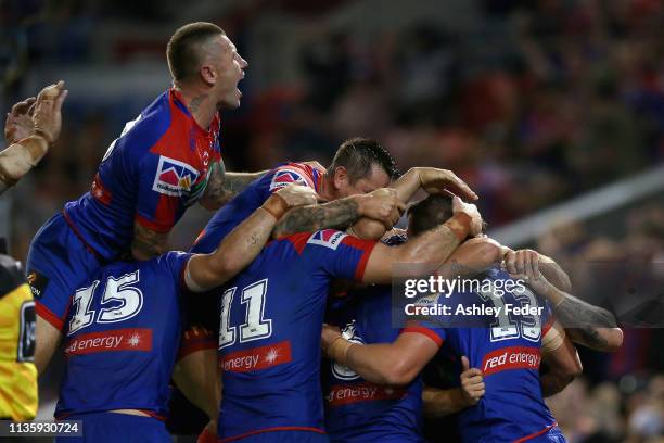 Knights celebrate a try from Tim Glasby during round one NRL match between the Newcastle Knights and the Cronulla-Sutherland Sharks at McDonald Jones...