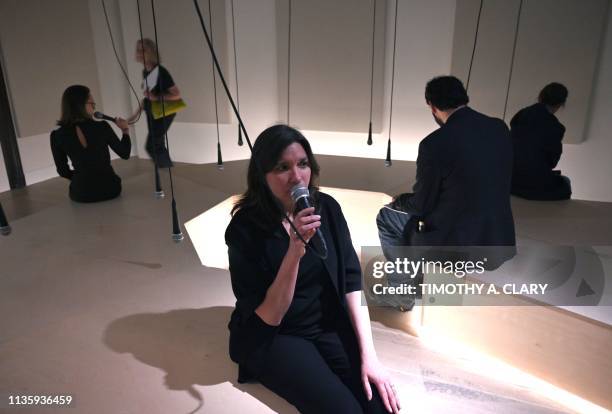 People try out the display " Daily tous les jours, I Heard There Was a Secret Chord, 2017" a participatory audio installation in an octagonal...