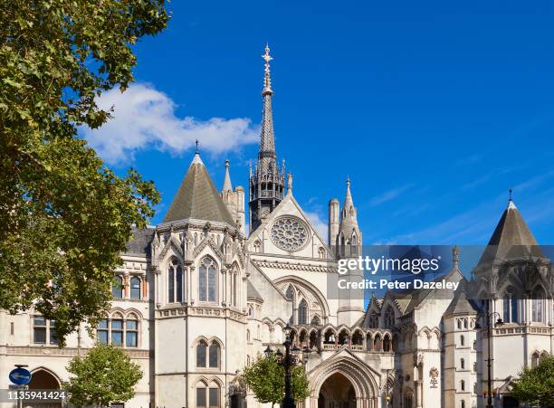 March 2019. Exterior view of the Royal Courts of Justice building on the Strand in London with the royal coat of arms and signage. The Royal Courts...