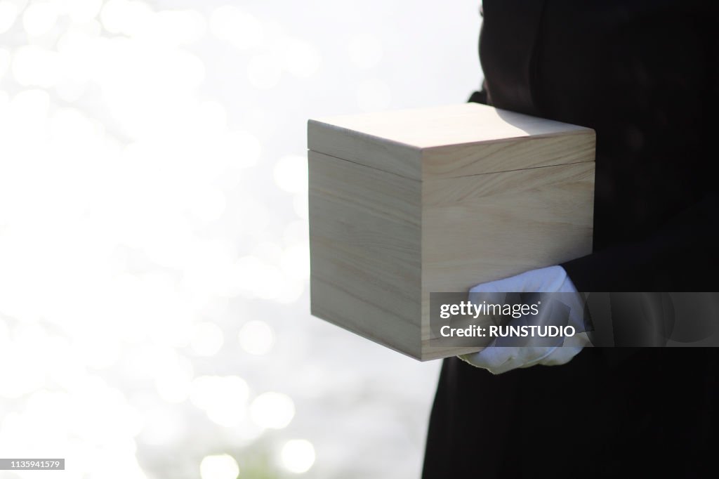 Mourner holding urn