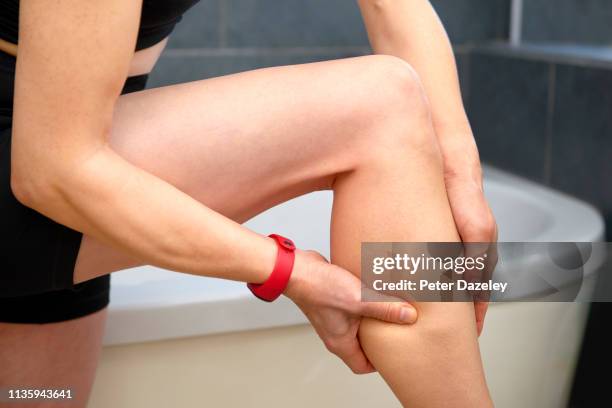 massaging pain in leg after exercise - older woman legs - fotografias e filmes do acervo