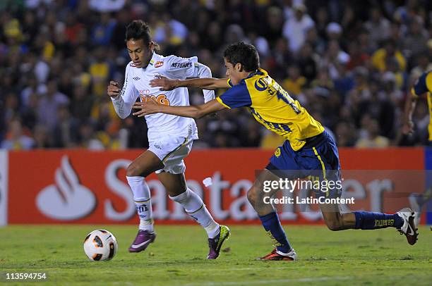 Diego Reyes of America of Mexico struggles for the ball with Neymar Santos jr of Santos of Brazil during the 2011 Libertadores Cup at the Corregidora...