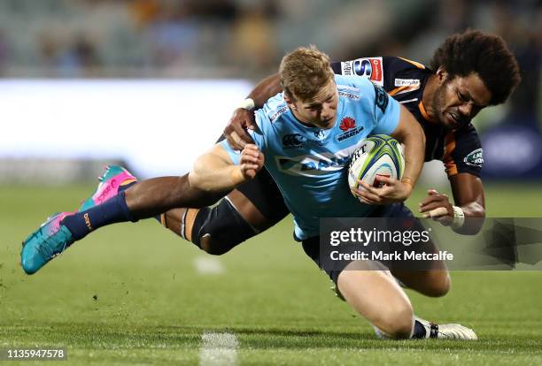 Alex Newsome of the Waratahs Is tackled by Henry Speight of the Brumbies during the round five Super Rugby match between the Brumbies and the...